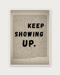 Keep Showing Up poster in white wood frame