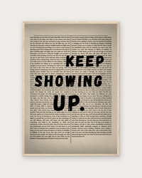 Keep Showing Up poster in natural wood frame